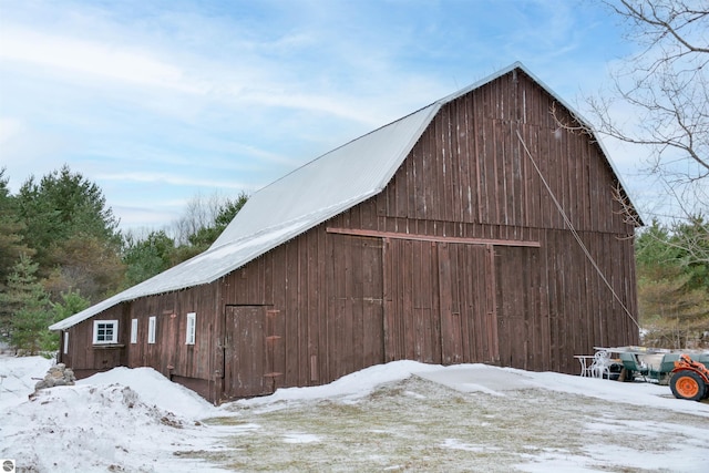 view of snow covered exterior with an outdoor structure