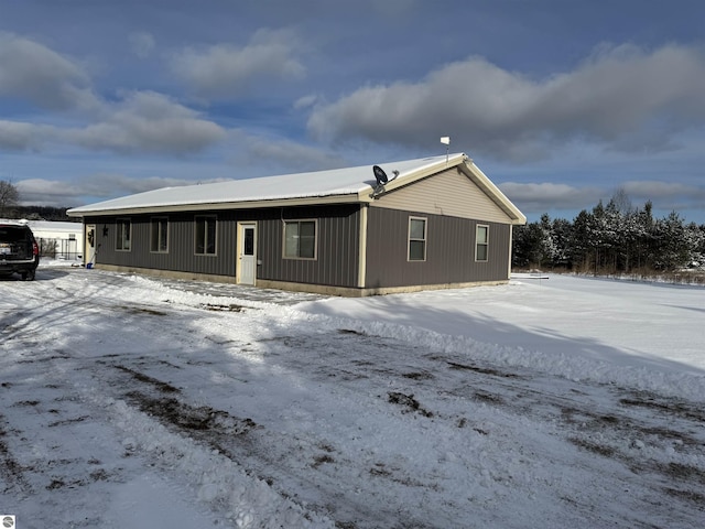 view of snow covered back of property