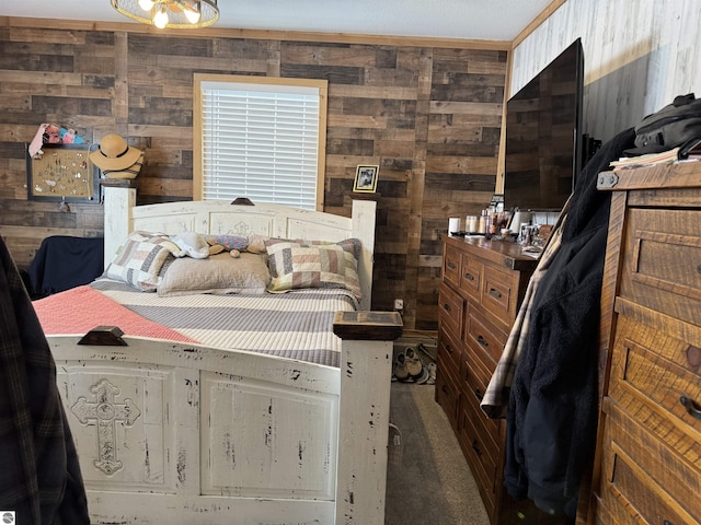 carpeted bedroom featuring wood walls and crown molding