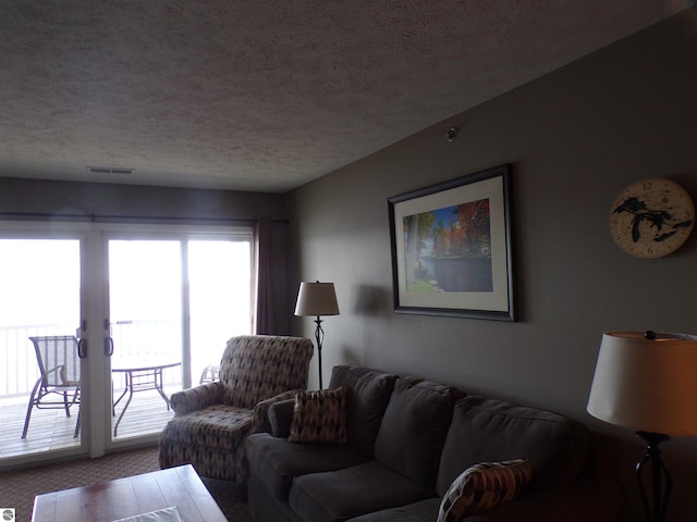 carpeted living room with a textured ceiling