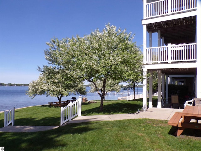 view of yard with a balcony and a water view