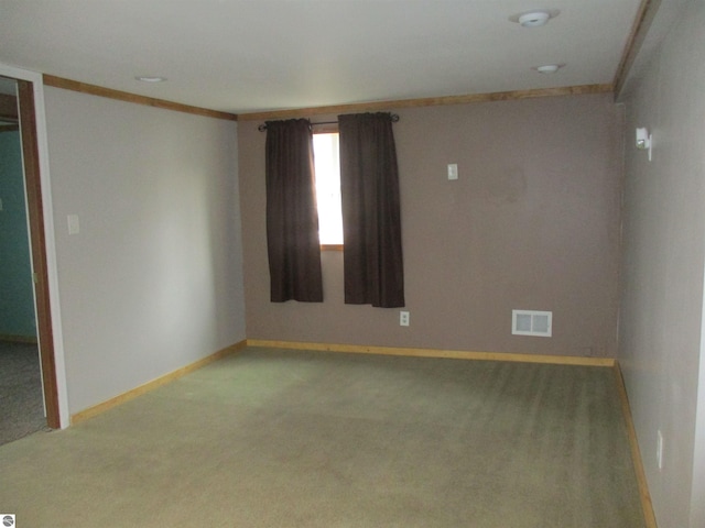 spare room featuring carpet flooring and ornamental molding