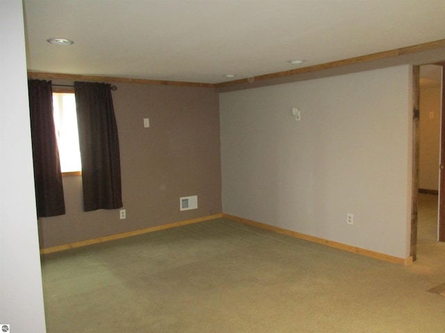 spare room featuring carpet and crown molding