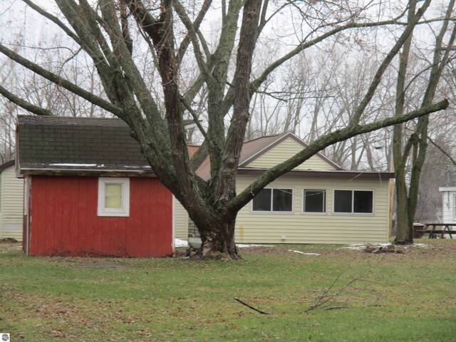 view of side of home featuring a lawn