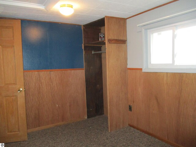 empty room featuring wood walls