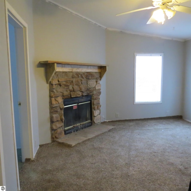 unfurnished living room featuring carpet flooring, ceiling fan, ornamental molding, and a fireplace