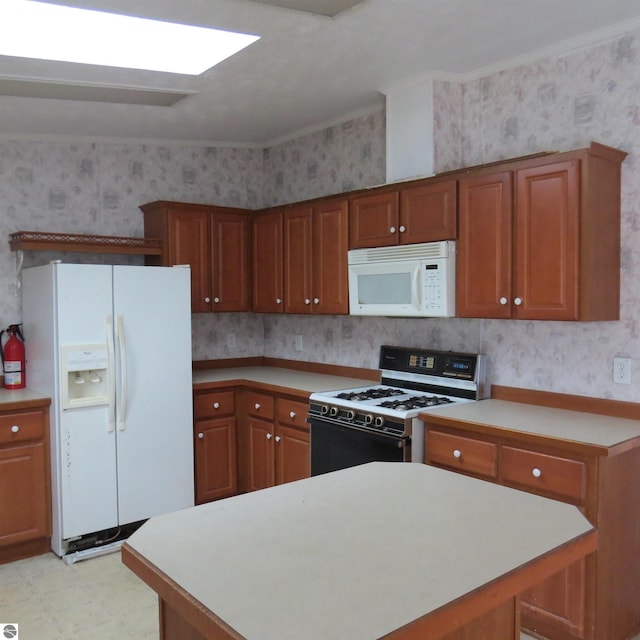 kitchen featuring white appliances and crown molding