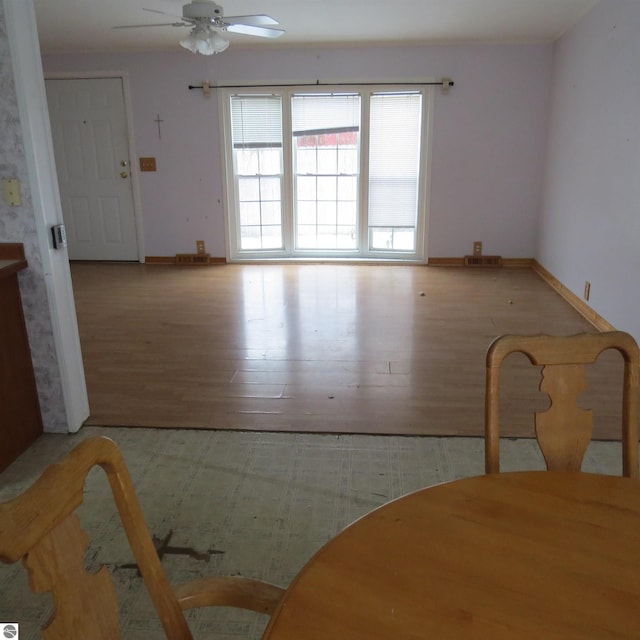 dining area with ceiling fan and light wood-type flooring