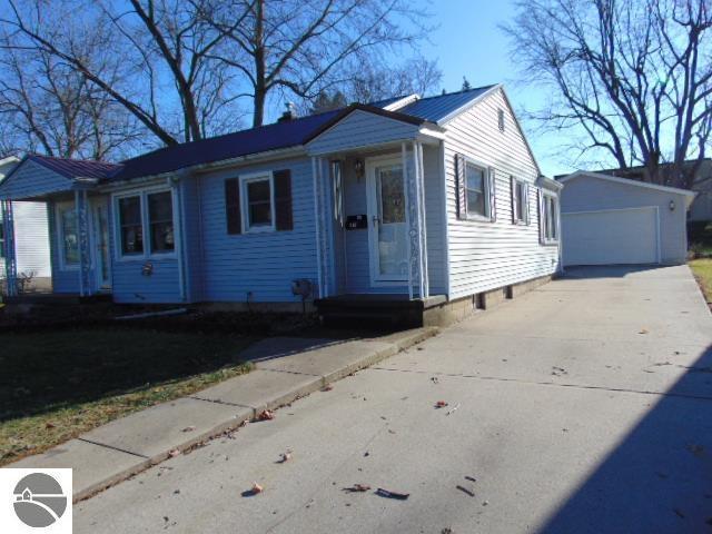 view of front of property with a garage and an outbuilding