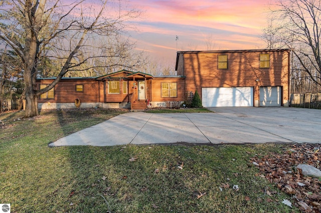 view of front of home with a lawn and a garage