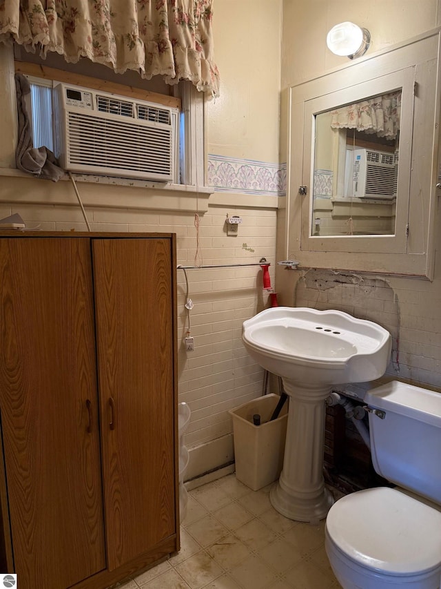 bathroom featuring cooling unit and toilet