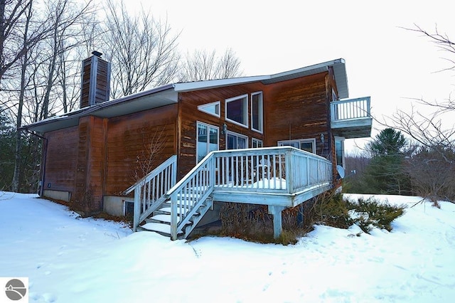 view of snow covered exterior featuring a balcony