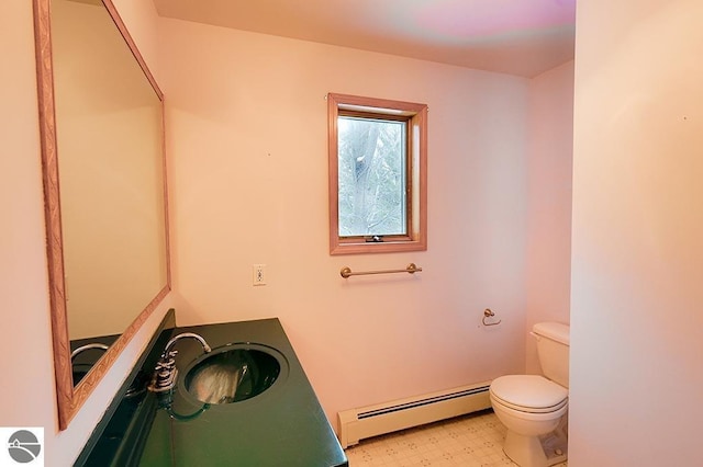 bathroom with vanity, a baseboard radiator, and toilet