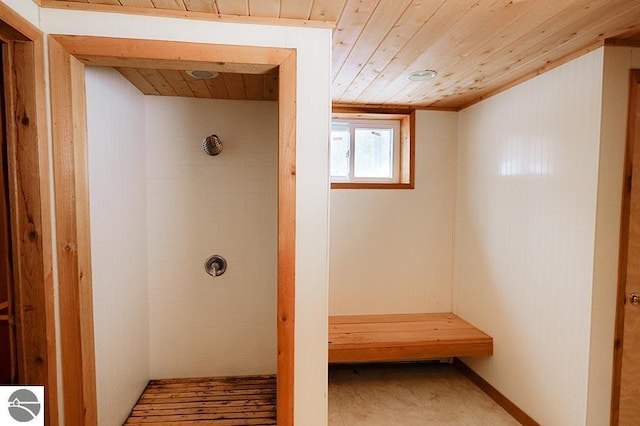 bathroom with wood ceiling and tiled shower