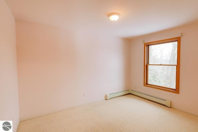 empty room featuring carpet floors and baseboard heating