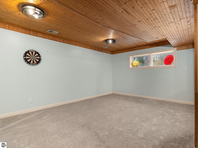 spare room with carpet and wood ceiling