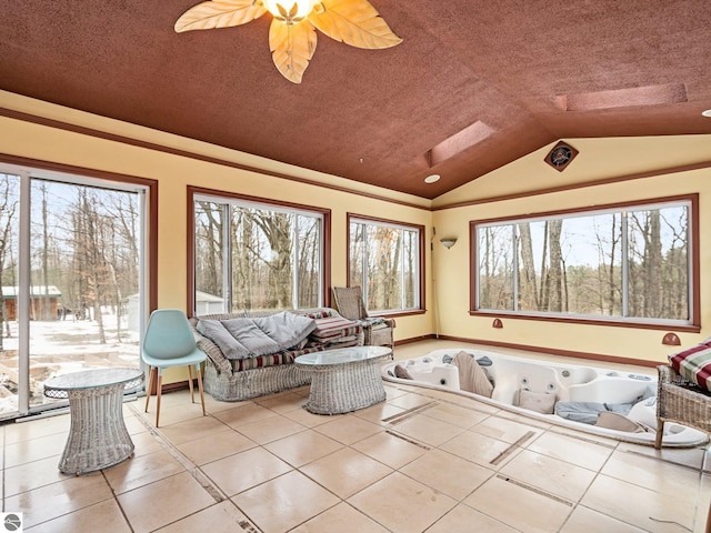 unfurnished sunroom featuring vaulted ceiling and ceiling fan