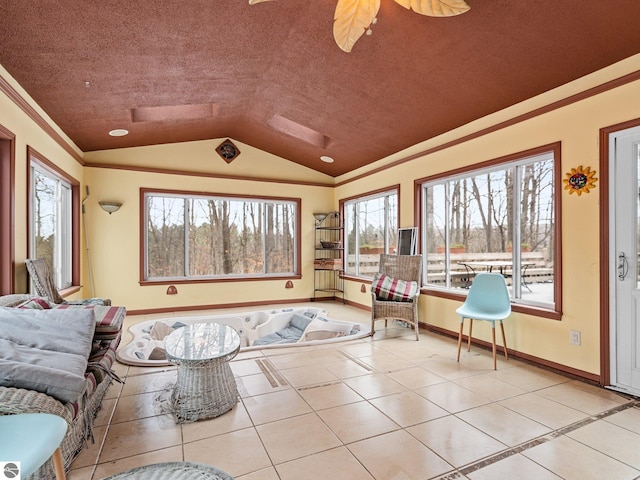 interior space with ceiling fan, a healthy amount of sunlight, and vaulted ceiling