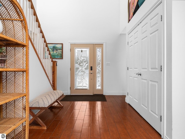 entryway featuring dark hardwood / wood-style flooring and a high ceiling