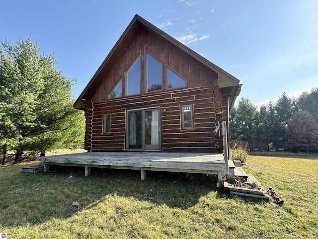 rear view of house featuring a yard and a deck