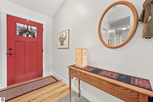 entrance foyer featuring vaulted ceiling and hardwood / wood-style flooring