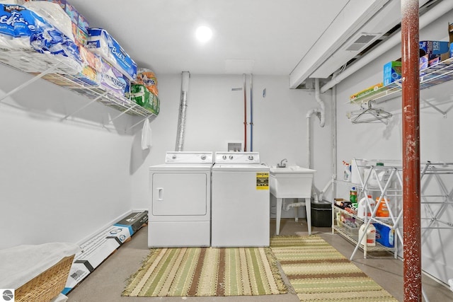 laundry area featuring separate washer and dryer and sink