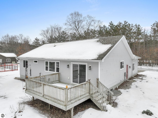 snow covered property featuring a deck