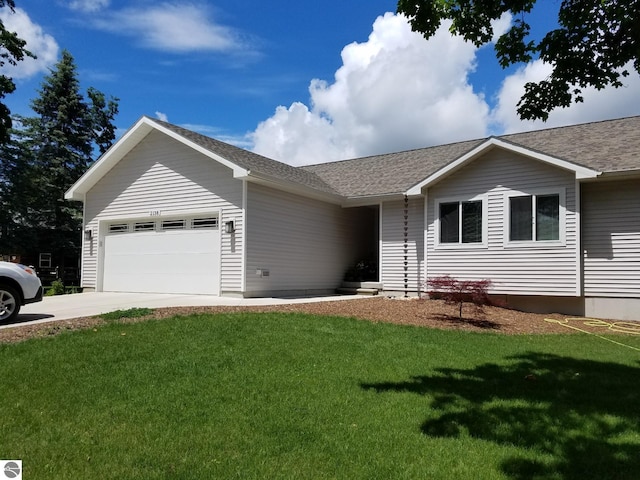 ranch-style home with a garage and a front lawn