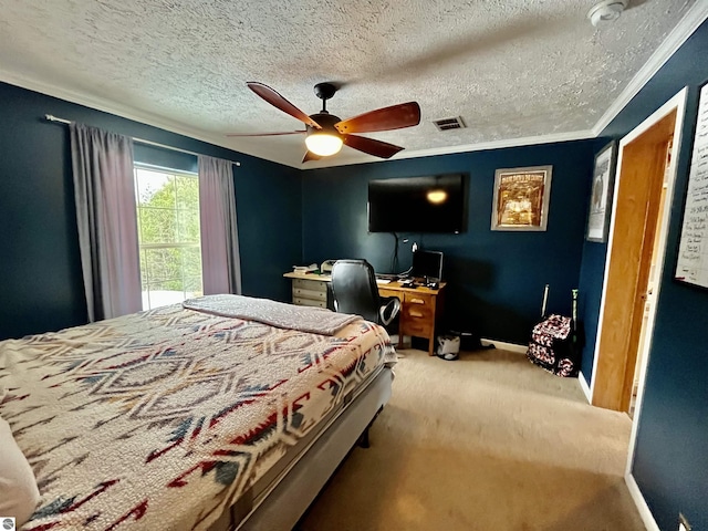 bedroom with a textured ceiling, carpet floors, ceiling fan, and ornamental molding