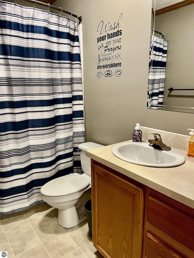 bathroom featuring tile patterned flooring, vanity, toilet, and walk in shower