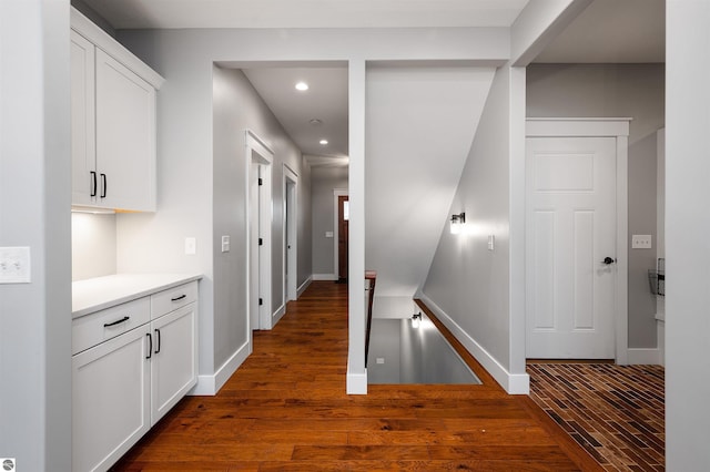 corridor featuring dark wood-type flooring