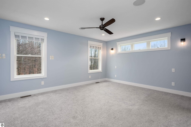 spare room with carpet floors and ceiling fan