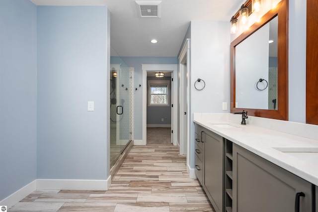 bathroom featuring vanity, a shower with shower door, and hardwood / wood-style flooring