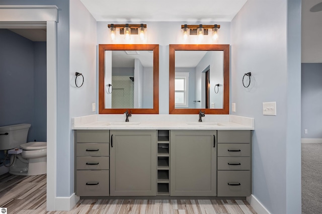 bathroom featuring vanity, toilet, and a shower