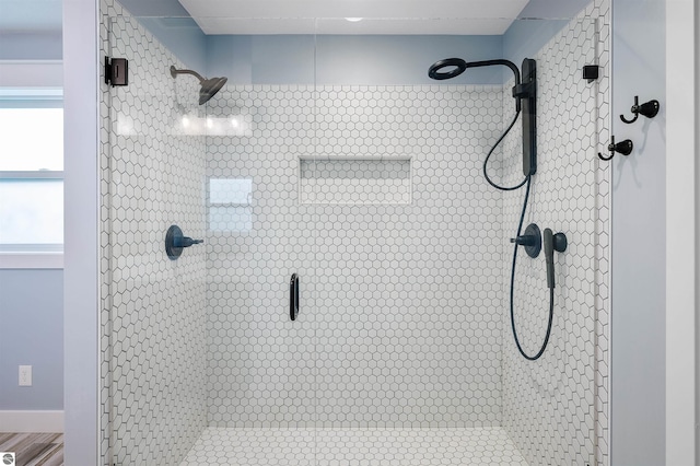 bathroom featuring a shower with shower door