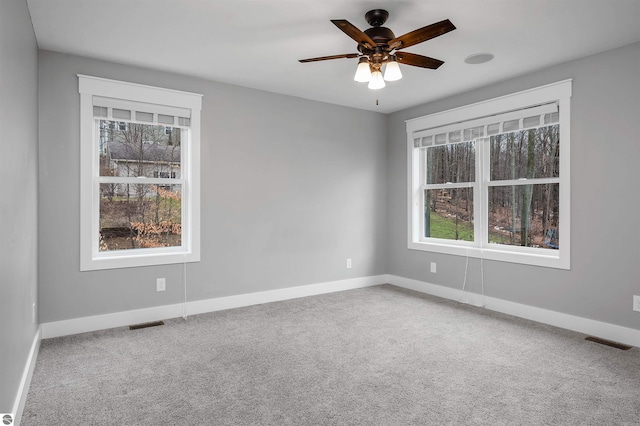 empty room with carpet flooring and ceiling fan