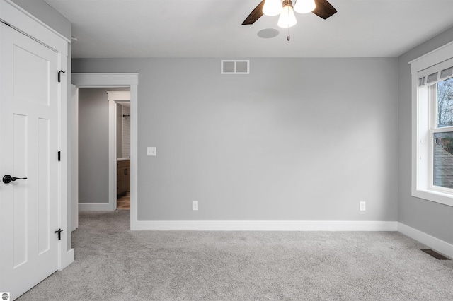 carpeted empty room with ceiling fan