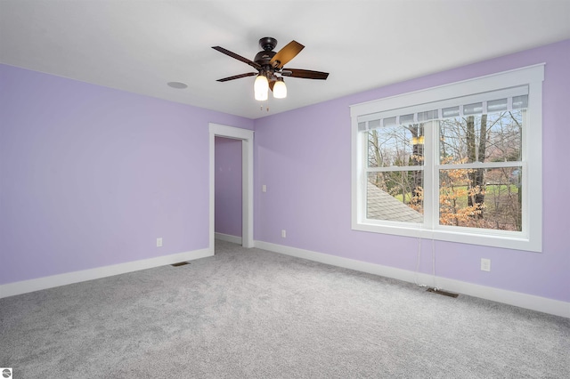 unfurnished room with ceiling fan and carpet floors