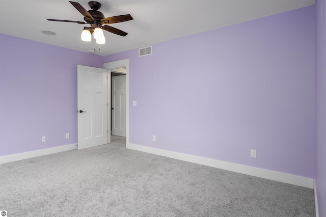 spare room with carpet and ceiling fan