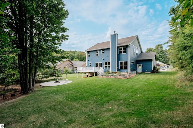 back of house featuring a patio area, a yard, and a deck