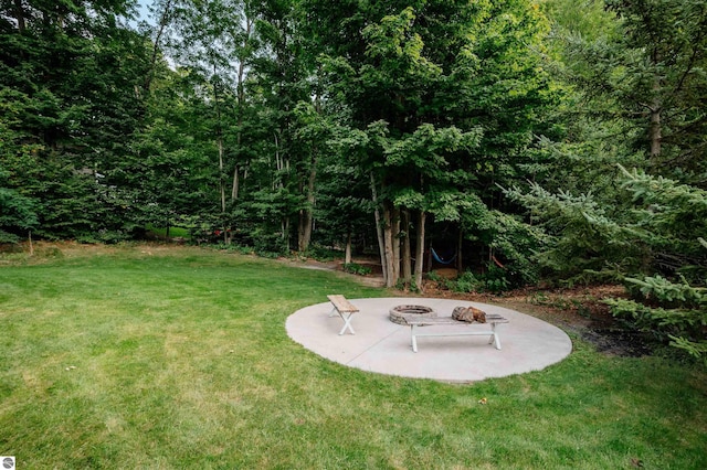 view of yard featuring a fire pit and a patio area