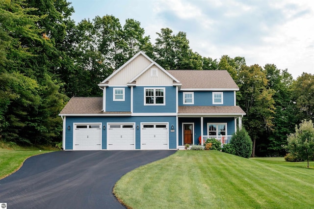 craftsman-style home with a front lawn, covered porch, and a garage