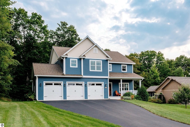 craftsman-style house featuring covered porch, a garage, and a front lawn