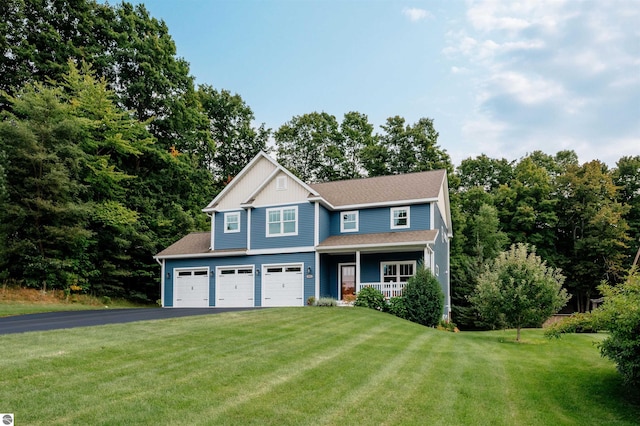 view of front of property featuring a front yard, a porch, and a garage