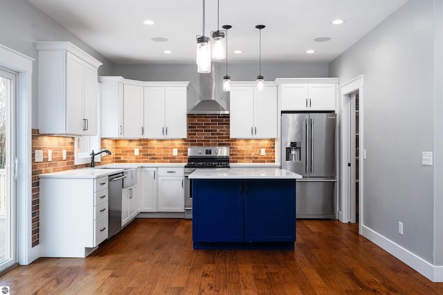 kitchen featuring white cabinetry, a center island, decorative light fixtures, and appliances with stainless steel finishes