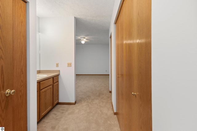 bathroom featuring a textured ceiling and vanity