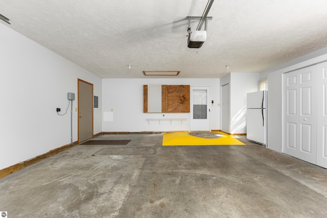 garage featuring electric panel, a garage door opener, and white refrigerator