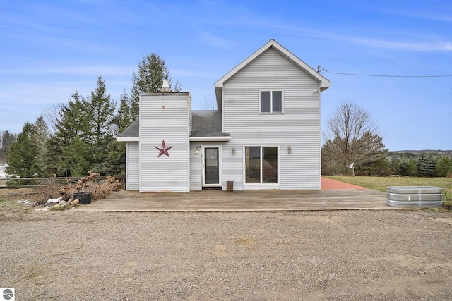 back of house featuring a wooden deck