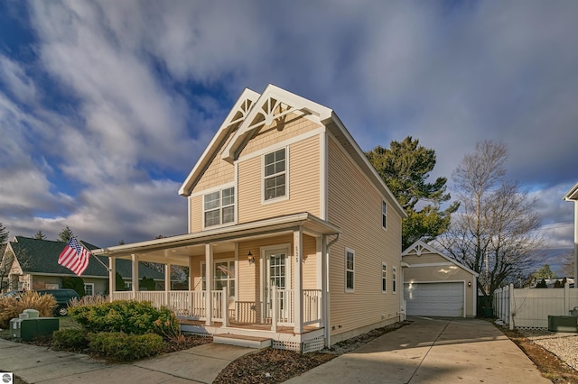 view of front of house with a porch, a garage, and an outdoor structure