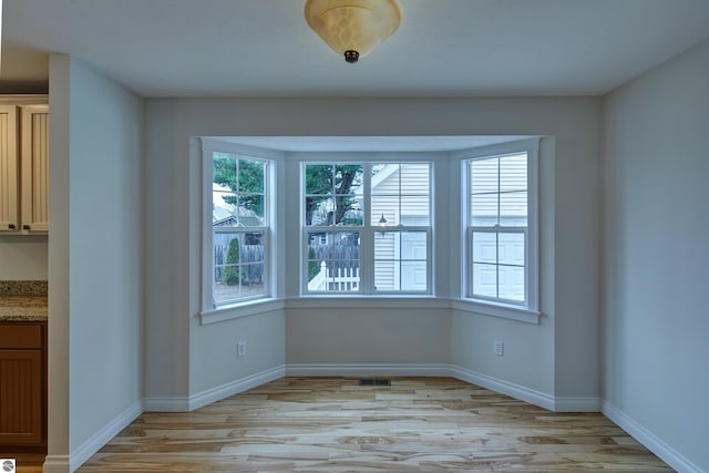 unfurnished dining area featuring light hardwood / wood-style floors